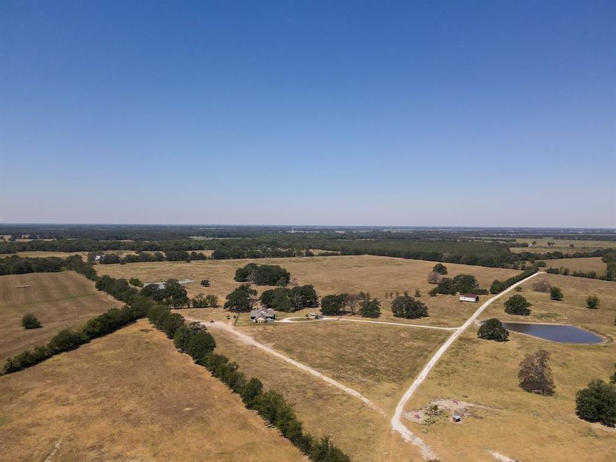 OUTSTANDING CATTLE-HUNTING RANCH! This tract has it all! The Red River county ranch is located 1.5 miles South of Bogata, TX containing 1,284 acres of prime property.  It is approx. 15 miles north of I-30 on St. Hwy 37 & CR 1112.  It is less than 2 hours from the Dallas metroplex.  There is a 2015 custom built 2,300 sq ft ranch home that is very nice with many extras.  A very large hay barn, a 3br 2 bath moderate foreman's house, several barns, a good set of cattle working pens & good fencing.  The property is approx. 2 thirds open sodded in native grasses, lespedeza, common bermuda and cross fenced.  The ranch will carry 250 cows. The wooded part of the property is mainly good hardwoods along Mustang creek.  It is home to a large deer, hog, squirrel and other varmit population.  This is an excellent fishing and hunting tract.  There are 11 stock ponds or lakes, a deep well and community water that serves the property.  This is truly a one of a kind ranch.