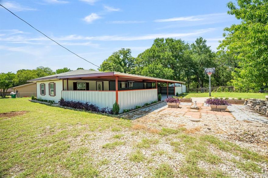 Nestled just outside the vibrant Granbury city limits, on a double lot, this charming 3-bedroom, 2-bath home has been updated throughout, blending modern convenience with a touch of countryside tranquility. Step inside to discover a seamless fusion of style and comfort, where every detail has been carefully considered. The heart of the home boasts a contemporary kitchen, featuring granite countertops, stainless steel appliances, and ample crisp white cabinets. Oversized living area along with the open concept kitchen and dining areas are bathed in natural light, creating an inviting space for both relaxation and entertaining. Retreat to the master suite, complete with a luxurious en-suite bathroom and a large walk-in closet. Outside, the property features a beautifully crafted rock retaining wall, providing a decorative area perfect for planting and adding your personal touch. An open patio offers an ideal setting to enjoy the outdoors, whether you're sipping your morning coffee or hosting evening gatherings. This home offers a perfect blend of peaceful living, easy access to city amenities and only minutes from Lake Granbury.