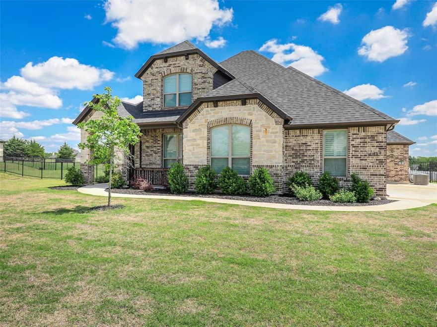 Experience elevated living on a full acre in the highly sought-after Maypearl ISD. This versatile open-concept home offers the flexibility of 4 bedrooms or 3 bedrooms plus a private office, along with a spacious media or game room designed for both entertaining and everyday comfort. Filled with natural light, the home features soaring ceilings, covered porches, and oversized spaces throughout, complemented by elegant plantation shutters installed throughout the home. The chef-inspired kitchen showcases granite countertops, an expansive island, stainless steel appliances, and beautifully crafted knotty alder cabinetry. The main-level primary suite offers a spa-like retreat with an oversized shower, garden tub, dual vanities, and a massive walk-in closet with direct utility room access. Upstairs, generously sized secondary bedrooms and a media room provide exceptional flexibility for modern living. Outdoors, enjoy a fully fenced acre complete with approximately 10,000 additional square feet of sod and a dedicated sprinkler system, creating an expansive and beautifully maintained outdoor setting. The finished oversized 3-car garage is enhanced with upgraded LiftMaster garage door openers featuring internet connectivity and combo keypad access for modern convenience and peace of mind. Adding even more value and durability, the home features a Class 3 impact-resistant roof replaced in March 2026. With no city taxes, this property delivers the perfect blend of luxury, space, functionality, and convenience.