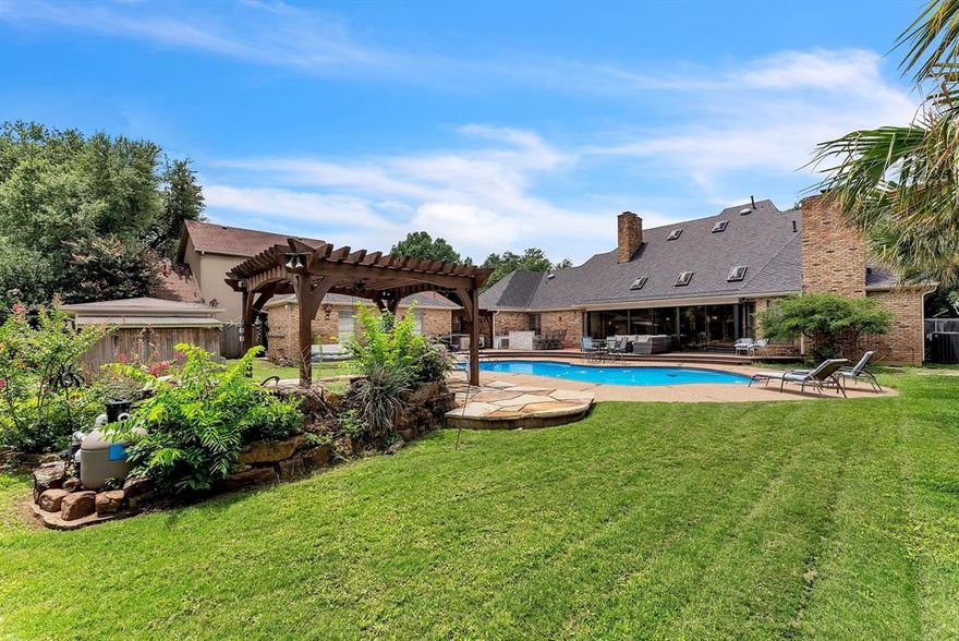 Located at the end of a well maintained cul-de-sac street, No 6 reflects the design architecture of a by gone area. The outside has Mediterranean feel about it but behind the massive 8 ft entry doors, a different story unveils. Mature oak trees embrace the circle drive way that allows ample parking. 
As you walk through the double entrance doors, you are greeted by a vaulted entryway. The main house has has 5 bedrooms, 3.5 baths and a separate Guest House, with it's own full bath. The kitchen is located off the living area with an over sized tiled island, a built-in refrigerator and a window greenhouse. The breakfast area includes a fireplace. The dining room has a bay window and is steps away from the kitchen. The master bedroom has an over sized walk in shower and a deep soaking whirlpool tub, two walk in closets and a fireplace.  The interior walls were just recently painted and the carpet was just replaced! The HVAC units were replaced in the last few years. The main house includes eight foot wood interior doors, ten foot ceilings and oversize custom crown & base molding. With three fireplaces, those winter days will be a thing of the past. Upstairs, you will have your own pub with a custom built bar, a Custom built pool table and a shuffleboard table. Down stairs is your perfect morning coffee spot, with an enclosed patio, overlooking the swimming pool. 
Outside has all the grandeur of a coastal resort. An over sized pool with a diving board, beside an outside kitchen complete with a Green Egg grill. A free standing hot tub, to help relieve those aches & pains away. Enjoy a flagstone dining area, with a custom built pergola and a waterfall Koi pond.  With six 12 foot tall palm trees you will be the envy of your friends! A 25’ x 13’ free standing building can become a guest house or pool room! Very seldom does a house in this neighborhood come up for sale and with all the amenities of this stunning home.