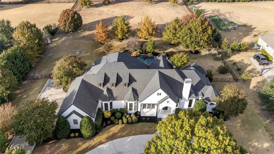 Set on a beautifully landscaped 1.57-acre lot in the coveted Twelve Oaks subdivision, this fully renovated 1-story estate blends modern luxury with timeless elegance in one of Prosper ISD’s premier neighborhoods. This stunning home has been transformed from top to bottom with a full renovation and every detail refreshed to perfection. A brand-new roof installed in 8-25, freshly painted brick exterior, and completely updated interior offer true peace of mind and exceptional longevity. Inside, every bathroom has been redesigned with elevated finishes, new carpet was added in 11-25. GE Monogram appliances were installed the same month. The kitchen shines with refinished cabinetry, sleek slab-quartz countertops, and a matching backsplash that highlights the home’s refined aesthetic. All light fixtures have been replaced, creating a cohesive, contemporary atmosphere throughout. Each spacious bedroom offers private or direct-access bathrooms, ensuring comfort and privacy. An oversized office with a fireplace provides an inspiring setting for productivity, while a large flex room delivers endless versatility—perfect as a media room, game room, or home gym. The luxurious primary suite includes a private sitting area, a spa-like bath with oversized shower, and two walk-in closets designed for superior organization. The chef’s kitchen boasts abundant cabinetry, a butler’s pantry, and expansive prep space ideal for hosting gatherings of any size. Step outside to experience Texas living at its finest with a resort-style pool and spa, covered porch, and a sprawling backyard shaded by mature trees offering beauty, privacy, and serenity. The 4-car garage with epoxy flooring and circular driveway provide impressive curb presence and ample parking. Additional highlights include a spacious laundry room, extensive landscaping, and exceptional curb appeal within a community celebrated for its peace, exclusivity, and upscale character. Don’t miss this rare, fully renovated gem.