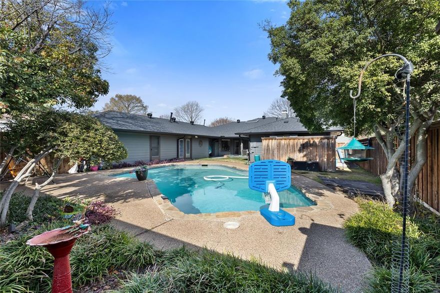 Set on a beautiful, established street in one of North Dallas’s most desirable pockets, this home offers a rare blend of flexibility, privacy, and resort-style living that truly stands out. Thoughtfully designed for the way people live today, the versatile floor plan provides exceptional functionality with a private, separate living suite ideal for extended household needs, long-term guests, a nanny arrangement, or a dedicated work-from-home environment with true separation from the main living areas. Multiple living spaces allow for effortless flow while still offering clearly defined areas for relaxing, entertaining, studying, or working remotely. Large windows fill the home with abundant natural light, highlighting updated finishes and hard surface flooring throughout for a clean, modern feel with no carpet. The formal dining room has been intentionally reimagined as a private office, perfectly suited for today’s flexible lifestyle needs. Recent updates add confidence and long-term value, including a newer roof, updated HVAC system, fresh exterior paint, and modern flooring, allowing buyers to move in and enjoy immediately. Outdoors, the backyard becomes a true retreat, featuring a sparkling pool and a covered patio ideal for morning coffee, weekend gatherings, or evening relaxation. The location further enhances the appeal, with nearby Campbell Green offering pickleball and tennis courts, walking trails, open green spaces, picnic areas, and a playground currently being renovated. Convenient access to dining, shopping, everyday amenities, and major commuting routes completes the package while preserving the charm of a quiet, tree-lined neighborhood. This is a home that delivers comfort, flexibility, and lifestyle-driven living in a location buyers consistently seek. Recently appraised for $905,000.