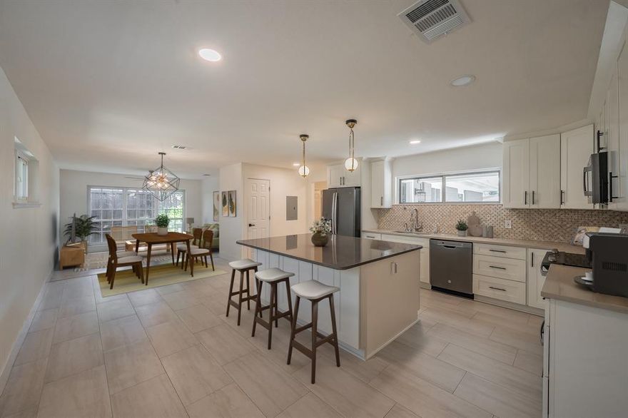 MOTIVATED SELLER! Welcome to this beautifully maintained midcentury gem that blends classic character with stylish updates. From the inviting front porch to the private backyard, every detail of this home has been thoughtfully designed for comfort and convenience. Featuring no carpet, this home offers tile and hardwood flooring throughout—perfect for low-maintenance living. The large, remodeled kitchen is a showstopper with an oversized island, quartz countertops, a plethora of cabinetry, soft-close drawers, big basin sink, and even a hot water spigot. Whether you love to cook or entertain, this kitchen has it all! A flex room off the kitchen can serve as a walk-in pantry, home office, or storage area, while two laundry options—traditional hookups near the kitchen or a stackable setup in the hallway—provide versatility and convenience. Both bathrooms have been tastefully remodeled with modern flair, offering sleek finishes and stylish functionality. Throughout the home, you’ll appreciate the absence of popcorn ceilings and the fresh, open feel of each space. Outside, enjoy a private backyard with a well-maintained fence and a storage shed that conveys, perfect for your outdoor tools or hobbies. The charming front porch is ideal for relaxing mornings or evening gatherings. Located in a convenient area close to shopping, restaurants, and highway access, this home is perfectly situated for easy living and quick commutes. With its timeless midcentury character, thoughtful upgrades, and move-in-ready condition, this property truly has it all. Don’t miss your chance to make this beautifully updated home your own!