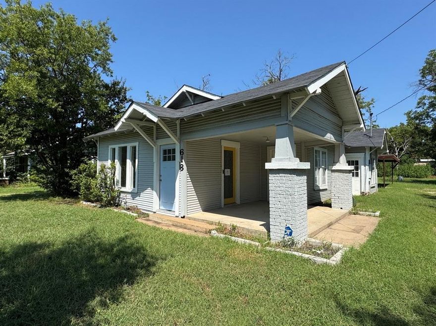 Great Price! Charming Craftsman bungalow on a spacious 0.407-acre lot in Cleburne, Texas. This 2-bedroom, 1-bath home features a covered front porch with Craftsman-style columns.  Inside offers a living room, dining area, utility room, and a kitchen with granite countertops, white cabinetry, and stainless steel appliances.  Washer, dryer, and refrigerator are included but the seller does not know their working condition.  The large backyard provides plenty of space for outdoor use, along with a metal carport for covered parking. Conveniently located near shopping, dining, schools, and with easy access to major roads.  All measurements, square footage, and school information are approximate and should be independently verified. This property is owned by the Secretary of Veterans Affairs and is being sold AS IS.
