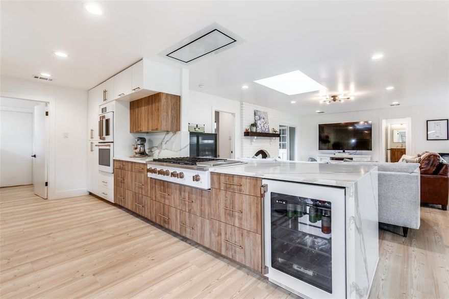 Sleek and crisp, this totally renovated home is packed with luxury updates and situated in a vibrant, established neighborhood. Not a flip, over 300K was spent on luxury cosmetic upgrades plus structural and mechanical improvements over the past five years. The open floor plan is a showstopper from the moment you enter the front door. The light-filled and expansive living, dining, and kitchen area offers endless opportunities for everyday living and entertaining. Luxury vinyl plank flooring connects all living areas and bedrooms. You'll love cooking in the stunning kitchen, which features Vicostone quartz countertops, GE Cafe Appliances, including a double convection oven, a recessed ceiling mount vent, and a 6-burner range with griddle. Custom cabinetry offers plenty of drawers. All three full bathrooms flow seamlessly together with similar finishes: new vanities, quartz countertops, classic tile, and new fixtures. Literally ripped down to the studs, other extras include vinyl windows, AC, sheetrock, ductwork, plumbing under the house, recessed lighting, and hardware and light fixtures throughout. Outside, the large backyard is surrounded by a stained horizontal fence and an electric gated driveway. For a complete list of improvements, see the transaction desk. With top-rated and desirable RISD schools nearby, that sense of community you've been craving can be found here. Great retail and restaurants are nearby. Less than 14 miles to downtown Dallas with two major highways nearby, it's a commuter's dream.