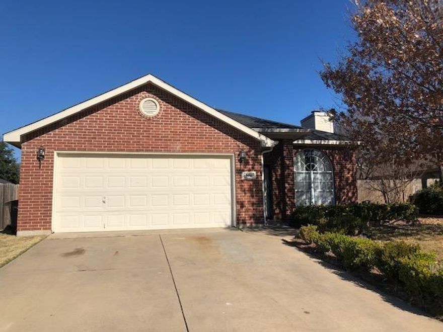 Classic brick house with two car garage, landscaped yard with tree in the front, 3 bedroom, 2 bath house, central heat and air conditioning, wood burning fireplace in the living area, stove and refrigeration, laminated and carpeted flooring, master suite with a garden tub and separate shower and two vanities, separate utility room, covered patio area in the back yard and wood fence. Decorator light fixtures and mini blinds.