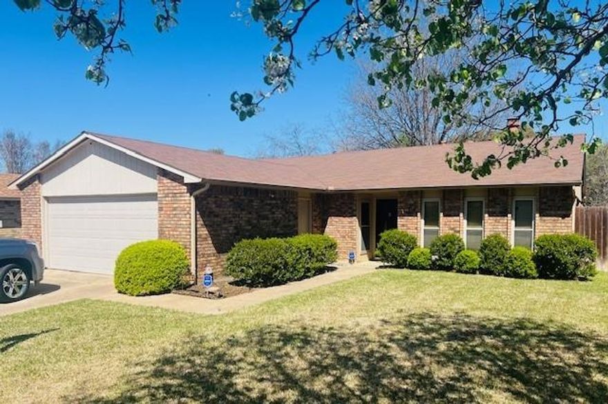 Charming ranch-style home featuring a warm and inviting living room with beautiful wood floors and a cozy wood-burning fireplace. This well-maintained property offers 3 spacious bedrooms and 2 full bathrooms, including a remodeled primary shower and a generous walk-in closet. The full kitchen comes equipped with a stainless steel refrigerator, microwave, electric cooktop, stainless sink and ample cabinet space.

Additional highlights include a two-car garage, a full-size gun safe, washer and dryer and a 10x20 storage building with workshop—perfect for hobbies or extra storage. Enjoy outdoor living on the covered patio overlooking a yard supported by a full sprinkler system. This home blends comfort, functionality, and convenience—ideal for everyday living and entertaining.  15 minutes from downtown Fort Worth and 5 minutes from first class shopping.