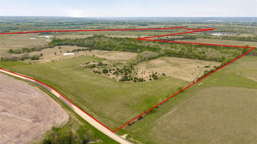 Located just southeast of Roxton, TX, this exceptional 340-acre tract offers a rare combination of agricultural productivity, cattle potential, and outstanding recreational value. With extensive frontage on both paved FM 2675 and County Road 25100, access is excellent, and a 4” water line provided by Lamar County Water Supply runs along the property for future development or ranch infrastructure.

The land features rolling hills that gently transition into over 60 acres of fertile bottomland—ideal for hay production or row crop farming. The remainder of the property supports a solid cattle operation with mixed native and coastal grasses, 7 small ponds, and a larger pond providing ample water sources across the landscape. Approximately 50 acres of mature woods, scattered shade trees, and natural cover create the perfect setting for livestock as well as abundant wildlife.

Cane Creek—with its rock bottom and year-round water—forms a scenic border and serves as a natural wildlife corridor. This area, along with the thick woods, provides ideal habitat for whitetail deer, turkey, and other native species. The property has experienced only low-pressure hunting over the years, and is known for producing large-bodied, trophy-class bucks.

Whether you’re looking for a working ranch, a productive farm, or a recreational getaway with investment potential, this Roxton property checks all the boxes 

Additional adjoining 83.94 acre tract as well as adjoining 43.36 acres also available for a total of 467 more or less acres to secure a sizable piece in Northeast Texas. See MLS 20905933 and 20904868