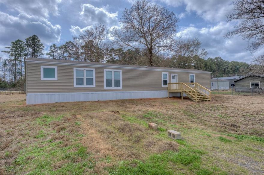 Discover comfort, convenience, and privacy in this newly remodeled 3-bed, 2-bath manufactured home situated on 0.9 acres in Minden. Fresh updates throughout give the home a modern, move-in-ready feel, while the spacious lot offers room to spread out and enjoy the outdoors.

The property is fully fenced, making it ideal for pets, children, or anyone who values security and seclusion. With road frontage on Highway 80 and immediate access to Interstate 20, commuting and travel are incredibly convenient—perfect for those who want country space without sacrificing accessibility.

Inside, the home features a bright, open layout with updated finishes, a refreshed kitchen, and comfortable bedrooms. Outside, the expansive yard provides endless potential for gardening, recreation, or future additions.

Whether you're looking for a starter home, an investment property, or a peaceful place to settle down, this Minden gem offers the best of both convenience and rural charm.