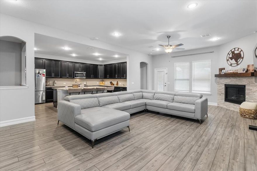 Welcome home to this exceptional custom residence in the highly sought-after Willow Ridge Estates of Haslet. Offering over 3,000 square feet of open-concept living, this recently constructed two-story home perfectly blends everyday comfort with unforgettable entertaining. Soaring two-story ceilings, abundant natural light, and an elegant staircase with wrought iron railing greet you in the foyer. Just off the entry, a versatile space serves perfectly as a private home office or formal dining room, ideal for both work and hosting. The expansive eat-in kitchen impresses with abundant cabinetry, granite countertops, smart appliances, and a built-in desk or bar area. Flowing seamlessly into the main living space, oversized windows showcase views of your resort-style backyard oasis—complete with a heated pool and spa, outdoor kitchen, and integrated landscape audio for year-round entertaining. The main-level primary suite offers a serene retreat with backyard views, a spa-inspired bath featuring granite countertops, garden tub, and custom walk-in closets. Upstairs, enjoy a massive family or game room perfect for a home theater, along with spacious guest bedrooms, each with walk-in closets. An epoxy-floored garage with custom storage, plus energy-efficient windows, smart thermostat, appliances, water heater, and irrigation system complete this incredible home. Designed for entertaining and built for comfort, this Haslet gem is a must-see. Schedule your private tour today.