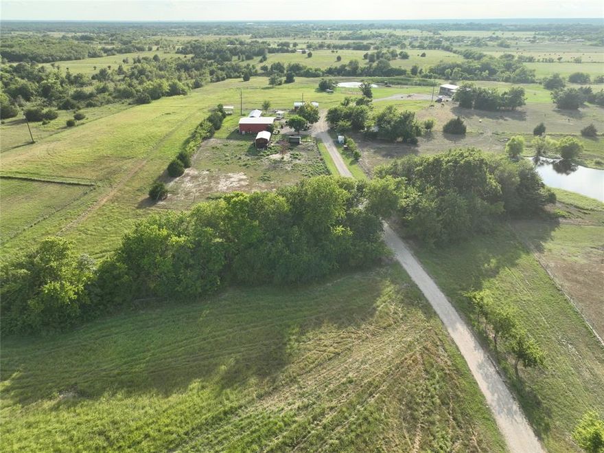 Discover over 33 beautiful acres featuring a nearly new 4-bedroom, 2-bath manufactured home, approximately 2.5 years old, set back with a circular driveway and a spacious 30' x 25' carport. The property also includes a metal shop on concrete slab with an attached studio apartment, perfect for guests, rental income, or workspace. A second carport with full utilities—electric, water, and septic—marks the site of a previous home, offering a prime spot for a new residence or future expansion. A private well is located on the property. The land is fully fenced and features an attractive pipe-fenced, gated entrance along with two separate driveways, providing multiple access points and endless possibilities.
Enjoy three ponds, one stocked with fish, and multiple picturesque sites ideal for building your dream home, guest homes, or even developing an RV park. Bring your ideas—this property offers exceptional versatility! Priced for quick sale!!
Additional Notes:
• Sellers are actively removing items; property will be fully market-ready soon.
• Leaseback may be required.
• Red and green Connex buildings may be purchased separately.
• Cattle on the property are also available for purchase.