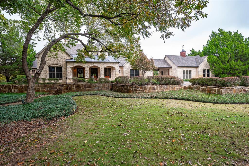 A rare find... 9 acres and a one owner, custom built, one story home in Grapevine. As you drive up the winding, stamped & stained driveway you will feel like you are in the country, though you are minutes from restaurants, stores & freeway access. The kitchen is a chef's dream with plenty of counter space (granite),  Viking stainless steel appliances including a built in refrigerator, gas range oven & warming drawer, island, & pantry. A focal point of the kitchen is the gas stove surrounded with Austin stone & tile. Private master suite with a sitting area & stone fireplace & windows that look out to the pool & the landscaped backyard.  Construction includes 2x6 walls. There is a well for watering the grass.  Roof replaced 2019. 2 HVAC units replaced 2017. The property is divided into 2 plats. The home is on 5.2 acres, the other plat is 3.71 acres & part of that land is in the 100 year floodplain, see  docs   in the Transaction Desk. The seller would like to sell both plats together.