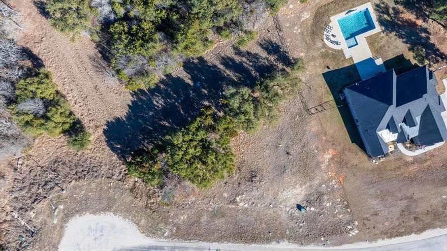 De Cordova Ranch welcomes you! One of Granbury's most desirable gated communities. This lot offers beautiful surroundings with a perfect opportunity to build your dream home in a quite, well maintained neighborhood. Several trees on this property. This community is close to Granbury Lake, Downtown Granbury, shopping, dinning, and more. Just minutes from Hwy 377 or commute to the DFW metroplex. Planning to build or invest in the future, this is a prime location. GPS is accurate. The community is gated so you will need an access code to enter. From Hwy 377, take Davis Rd south. Turn left onto De Cordova Ranch Rd. where the gate is located. Turn left on Legends Trail and follow around to the back on the subdivision. Buyers, text agent for code to drive by and view the lot.
All information is deemed reliable but buyer and buyers agent should confirm for accuracy.