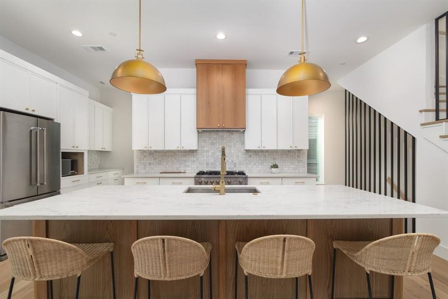 Crafted by the renowned Strange and Sons Development, Cedar Springs Townhomes delivers twenty one modern residences in the heart of Dallas. Interiors are bright and refined, planned for natural light and easy flow. The main level centers on a chef kitchen with white cabinetry, warm wood accents, brass hardware, and Calacatta style quartz on a generous island with an under mount sink. A marble backsplash, brass dome pendants, and a premium stainless package with a six burner gas range, hood, French door refrigerator, built in microwave, and dishwasher complete the space. The great room brings wide plank oak floors, a window seat, and sliders to a private balcony. Upstairs, a spa bath offers dual quartz vanities, oval mirrors, globe lighting, and brushed brass fixtures. The wet room is enclosed in frameless glass and places a freestanding soaking tub inside the shower for a true retreat, with walk in storage nearby. Many plans add a flexible loft for media, office, or guests, with floating shelves and a compact cabinet bar. Outdoor living shines with covered and open balconies, and select homes provide expansive rooftop terraces with a shaded pergola and city views. Architecture is clean and contemporary with strong curb appeal. From this central address you are close to Oak Lawn and Uptown dining and nightlife, the Katy Trail and Turtle Creek Park, West Village, Downtown, the Medical District, the Dallas North Tollway, and Dallas Love Field. Cedar Springs Townhomes pairs elevated finishes, flexible spaces, and a walkable location, with the craftsmanship of Strange and Sons Development.