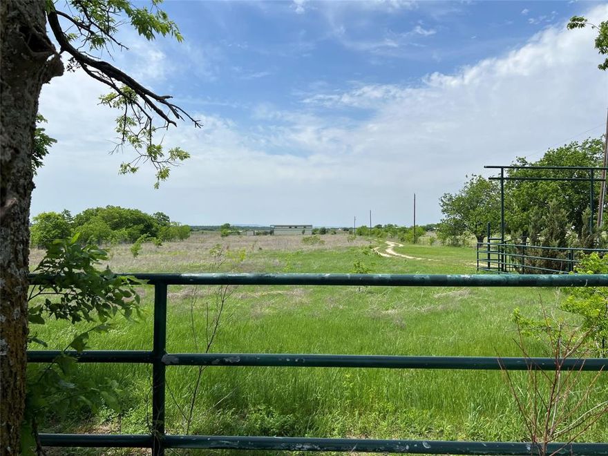 Gorgeous 70+ Acre Country Retreat!! This 70.467-acre property offers privacy, stunning views, and the perfect country living experience, just minutes from Godley. Enter through a private electric gate and enjoy panoramic vistas that stretch across the land, creating an idyllic setting for relaxation or ranching. With a spacious barn featuring nine stalls, a tack room, wash bay, and vet room, this property is ideal for horse lovers. Two paddocks, a round pen, and a walking area provide plenty of space for training and exercise. The lush pastures offer ample grazing space, making it perfect for equestrian operations or a hobby farm. The two-bedroom, 1,100-square-foot living quarters offer a cozy, rustic retreat with stunning views. Whether for weekend getaways or full-time living, the cabin is a peaceful escape, providing a comfortable base to enjoy the surrounding nature.  Although secluded, this property is only minutes from shopping, dining, and the top-rated Godley schools, offering the perfect balance of rural serenity and convenience. With over 70 acres of land, this property offers endless possibilities for a dream home, ranch expansion, or future development, all while maintaining controlled access and privacy.