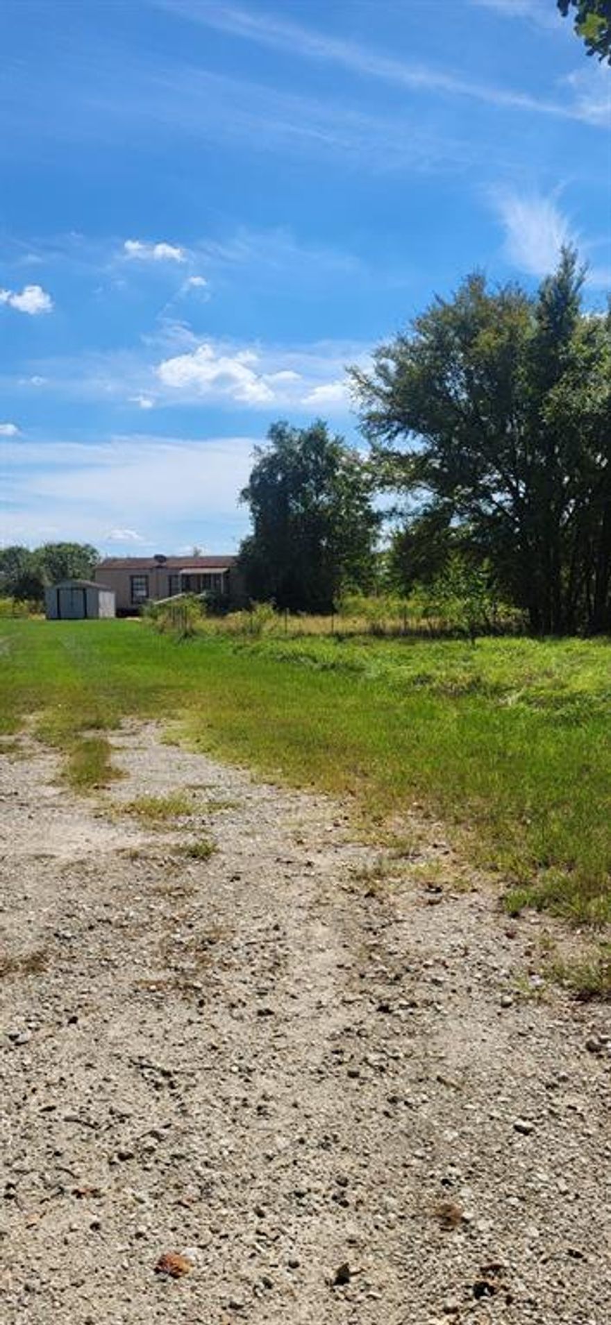 Open 5plus acres , a peaceful setting.  location near Kemp, Seven Points, Hwy 175 easy drive to DFW area. 
 Level acreage, grasses, with shrubs and trees  recently brush hogged back acres.  Tree and shrub lined at frontage road for  partial privacy.  Open views, elbow room to build.  OK to  build or place Mfg home, room for boat and RV, 
or expand on large slab pad site.  Tiny home has a full bathroom, utility area , open floorplan, kitchen with appliances remaining. Under 700 square feet with good views.  Fenced dog run or pet area front right of ramp to covered deck, porch.  Storage building visible.  Septic goes to left back
and plenty of possibilities with this property. Close to Cedar Creek Lake and shopping, entertainment  and sport areas.  Allow me to show you!