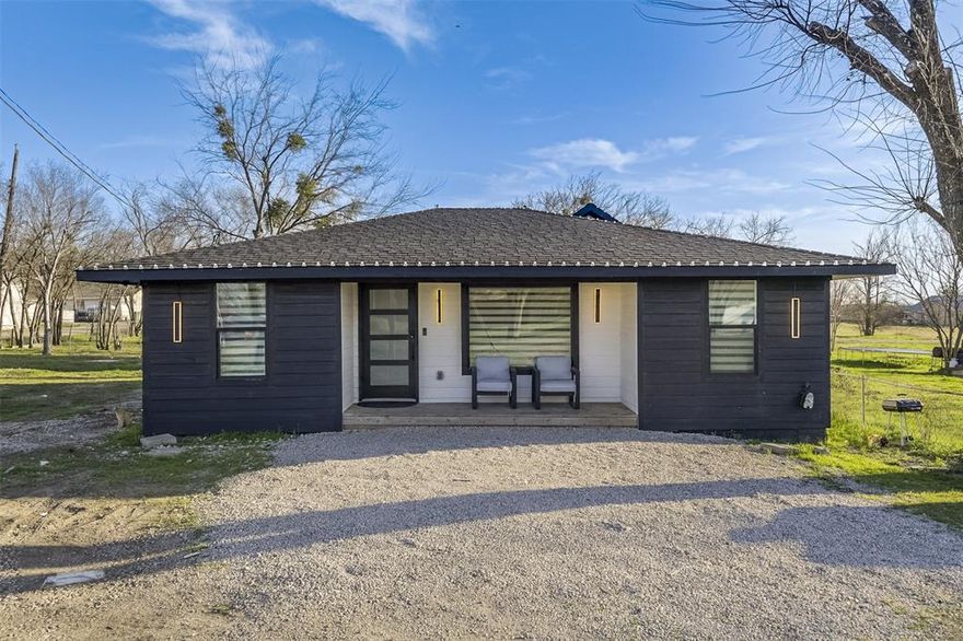 Beautifully updated inside and out, this 3-bedroom, 1 bath home in Ferris TX offers modern style and thoughtful upgrades throughout. Originally a 2-bedroom home with 934 sq ft, an additional approx. 150 sq ft was added to create a spacious third bedroom and square footage to be verified by appraiser. The exterior features updated siding along with inviting front and back porches. Inside, the open-concept layout flows seamlessly from the upgraded kitchen—complete with quartz countertops, abundant black cabinetry, open shelving, electric cooktop, and included a microwave and refrigerator—into the dining area and living room. The living space is enhanced by a wall-mounted electric fireplace, decorative lighting, and built-in shelving. Bedrooms offer roomy closets, including a generous walk-in closet, plus additional built-ins for storage. The bathroom features a solid ceramic countertop and modern finishes. Major improvements were completed in 2022, including the roof, HVAC, water heater, foundation repairs, and other upgrades, giving peace of mind to the next owner. Dual-layer light-filtering roller shades add a clean, contemporary touch throughout. 
Please note: The storage shed located in the backyard extends a few feet onto the neighboring property. The shed will need to be removed or relocated.