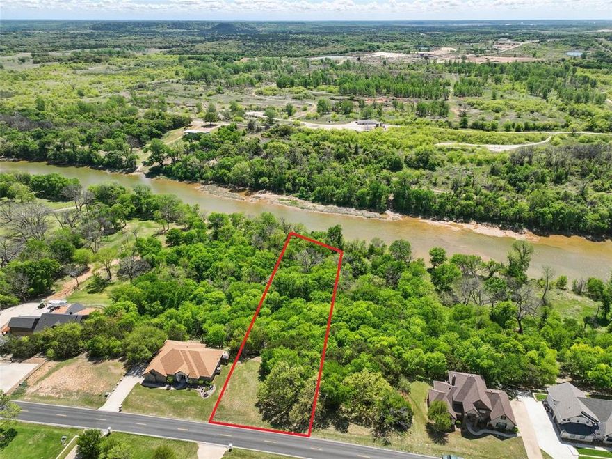 Rare Brazos Riverfront Lot in Pecan Plantation! One of the last remaining true riverfront lots in Pecan, this is your chance to own a slice of heaven. With 102 feet of prime Brazos River frontage, this lot is just under an acre and loaded with mature trees. It’s peaceful, private, and absolutely beautiful. Wooded, quiet, and full of wildlife! You’ll see deer everywhere, owls in the trees, and enjoy the natural beauty that surrounds you in every direction. Bring your own builder and build the dream home you’ve always wanted. Whether you’re planning a weekend retreat or your forever home, you’ll have direct river access from your own yard, perfect for fishing, kayaking, or just relaxing by the water. Mornings under the trees, afternoons on the river, and evenings by the fire, this is the kind of place you won’t want to leave. And the best part? You won’t have to! Pecan Plantation is its own self contained community with everything you need right inside the gates, grocery store, bank, vet, salons, Ace Hardware, restaurants, gas station, marina, equestrian center, archery, RV park, tennis courts, pickleball, two championship golf courses, a voluntary fire department, and SO MUCH MORE!  It’s gated, guarded, and offers a lifestyle like no other. Visit ppo.web for a full list of amenities and come see why so many people fall in love with life here!