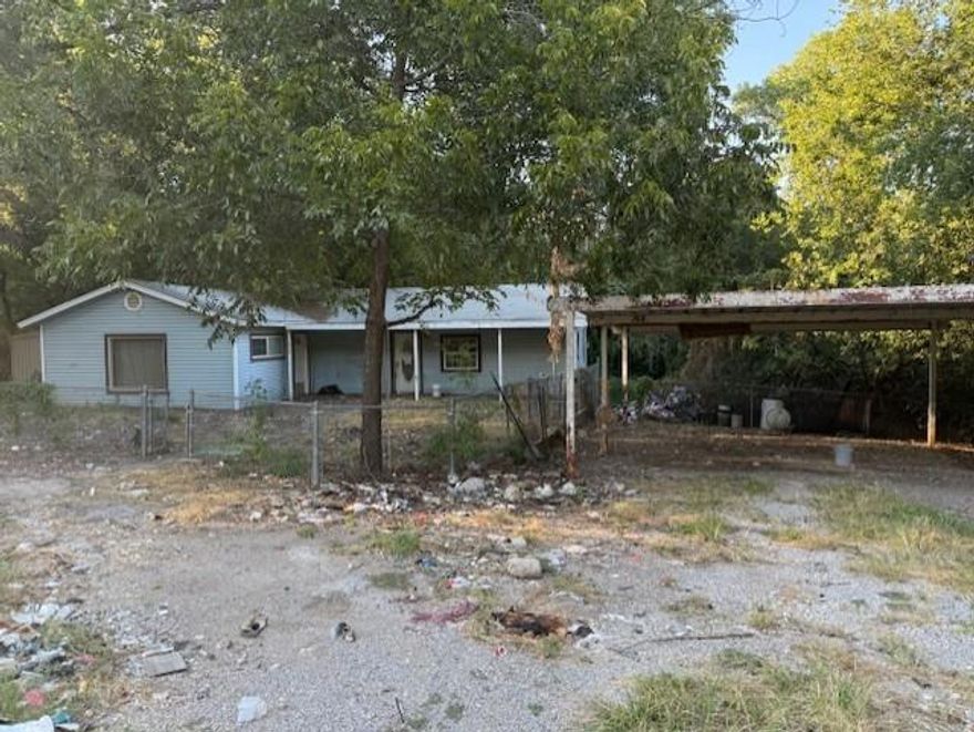 The home has an enclosed garage for the extra living space, and the front room can be a bedroom or dining room right off the kitchen.  Your creative thoughts can make this home what you choose it to be. There is also a basement room that can be another bedroom if needed. Backs up to a creek, so there is privacy. This property will be sold as is, and the utilities will not be turned on by the seller.