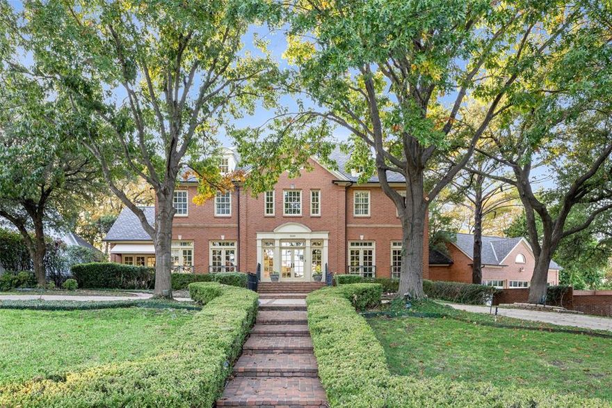 Set on more than two wooded acres, this property offers a rare blend of seclusion, nature, and refined living. Elevated on a bluff overlooking the water and natural river corridor, the home enjoys sweeping views framed by mature trees and lush surroundings—all while remaining close to modern conveniences. A circular drive provides an elegant approach and a welcoming sense of arrival.

The main brick residence spans 6,037 square feet with 4 bedrooms and 5.1 baths. Inside, classic architectural elements complement tall ceilings, generous windows, and thoughtfully designed living spaces. Formal living and dining areas create an inviting atmosphere for entertaining, while the spacious family room and breakfast nook overlook the grounds and pool. The kitchen offers ample cabinetry, a walk-in pantry, and plenty of workspace for everyday use or hosting. Each bedroom includes an ensuite bath, and a third-floor bonus room provides flexible space for media, play, work, or hobbies.

A separate 1,018-square-foot guest house enhances the property’s versatility with a bedroom, 1.1 baths, a full kitchen, and a living area. Beneath it, a temperature-controlled basement wine cellar offers storage and presentation space ideal for collectors and entertainers.

Outdoor living takes full advantage of the setting, with a sparkling pool, stone pathways, shaded lounging areas, and expansive lawns surrounded by natural terrain and mature trees—creating a sense of privacy rarely found in established neighborhoods.

Located near River Legacy Park, nature trails, Lake Viridian amenities, and major highways, the home provides effortless access to shopping, dining, entertainment, and DFW Airport. Blending space, natural beauty, and modern convenience, this property is perfectly suited as a primary residence, multigenerational retreat, or legacy estate.
