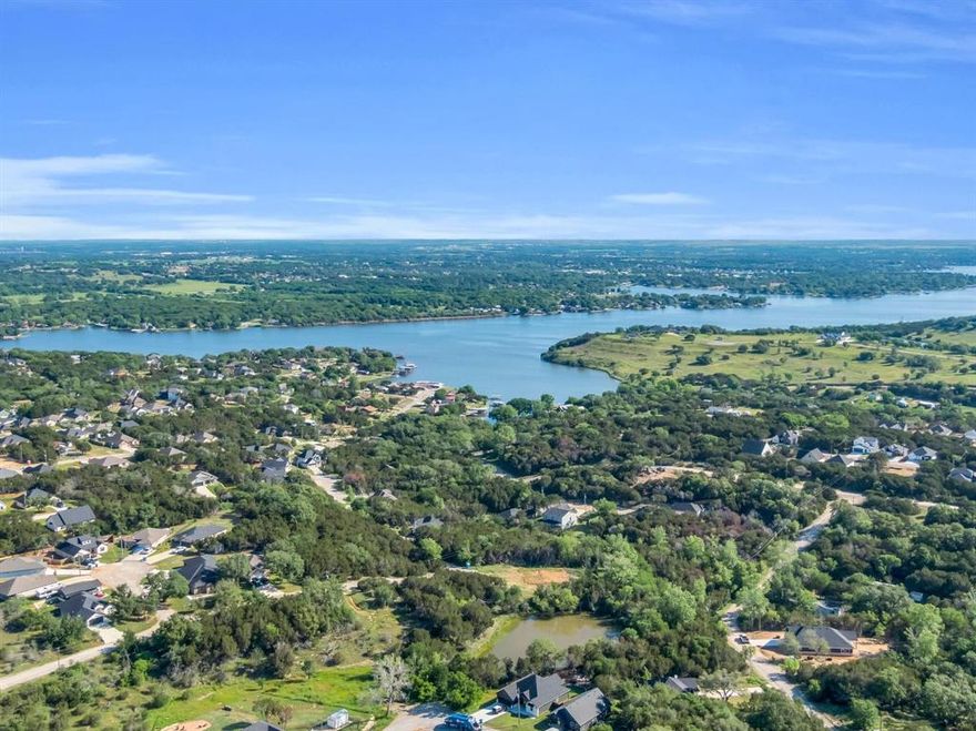 Ready to enjoy the lake life in Granbury in the premier gated community of Canyon Creek? This property has water and electricity, a large propane tank and a septic system already located on the property! Convert this property to your dream home or scrap the mobile and build to suit!
