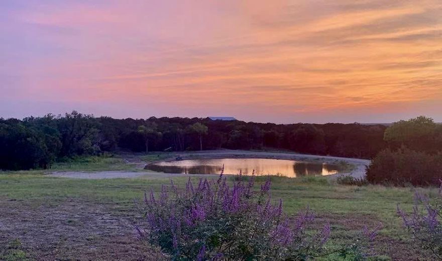 The Seller's sense of urgency could be your lucky ticket!  Build Your Texas Dream on Nearly 23 Acres.  This scenic ranch property offers just under 23 unrestricted acres of gently rolling Texas land with panoramic views, vibrant sunsets, and a strong foundation already in place for your ideal homestead or rural retreat.  The beautifully updated barndominium includes granite countertops, a new tile backsplash, newer appliances, luxury vinyl plank flooring, and a spacious walk-in closet. It is available furnished, making it easy to move in and enjoy while you plan your future build.  The property also includes multiple outbuildings such as a workshop with power, a detached office with air conditioning, a storage barn, two carports, and a loafing shed. A fully furnished guest house with carport, deck, washer and dryer, tankless water heater, and thermostat controlled crawlspace vents offers flexibility for rental income or multigenerational living.  A new private road and electric gate were recently added, providing secure and convenient access from the main road straight to the heart of the property.  Additional features include a private gun range with berm, two water wells, and a stocked tank with bass and bluegill.
Whether you are looking for a peaceful weekend retreat, a full time ranch lifestyle, or a long term investment, this property offers endless potential in a spectacular Texas setting, now priced well below market value.  Make it yours today!