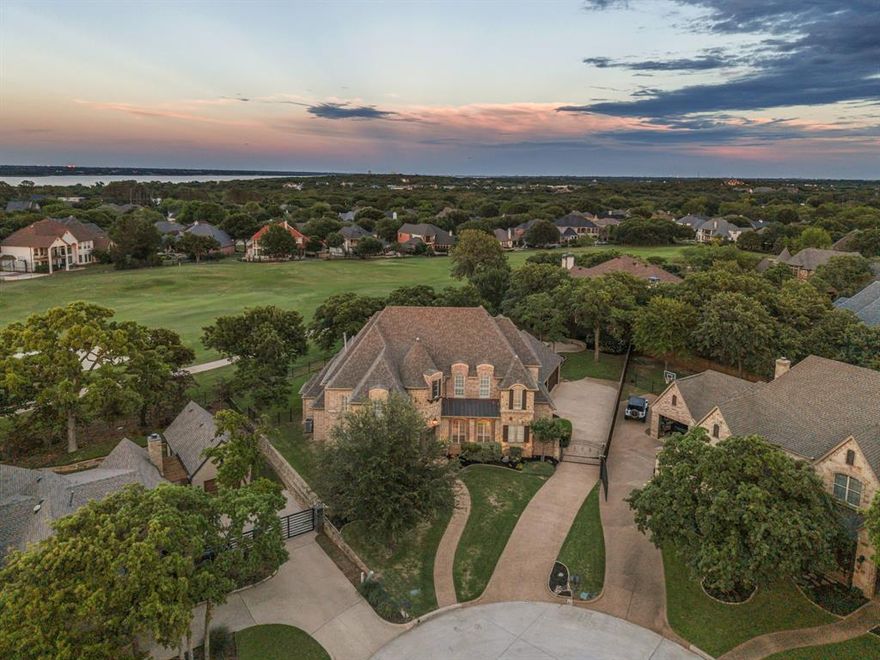 Multiple Offers Rec'd Overlooking the 14th of Trophy Club’s Whitworth Course and nestled at the end of a quiet cul-de-sac in The Knoll, this custom-built 5-bedroom home offers expansive golf course frontage and serene views from nearly every room. Remodeled in 2025-2026, every space has been refreshed with thoughtful design and modern finishes that blend comfort, luxury, and functionality. Refinished hardwood floors, quartzite and quartz counters, updated lighting, new carpet, designer selected backsplash and floor tiles. At the heart of the home, a stunning quartzite-topped kitchen island invites gatherings and conversation, opening seamlessly to the light-filled family room with center-opening sliding doors that frame the outdoor living area and picturesque golf course beyond. The open-concept layout is ideal for entertaining or relaxed weekends at home.
Step outside to a spacious covered patio featuring travertine pavers, a gas fireplace, a large firepit, outdoor grilling station and sparkling pool shaded by mature trees—perfect for cooling off on summer afternoons or hosting friends for evening get-togethers. The first-floor primary suite provides scenic views and a beautifully remodeled bath with dual walk-in shower. A private guest room on the main level offers flexibility for visitors. A formal office provides privacy to tackle work from home. Upstairs you’ll find three additional bedrooms, a large game room with wet bar, vaulted ceiling media room with stone accent wall, and a generous craft-laundry room featuring a sink, stacked washer-dryer space, and extensive counter space for folding laundry, wrapping gifts, or creative projects.
This home blends sophistication and ease of living with timeless finishes, dramatic architecture, and a prime Trophy Club location just moments from award-winning schools, parks, and community amenities. Mechanical updates include a roof (2021), tankless water heater, and two recently updated HVAC systems and central vacuum.