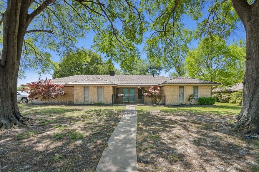 As you approach the huge corner lot with towering trees you know you have arrived at home! An open entry with custom banister invites you to the over sized den with beamed ceiling, cozy fireplace, luxury plank floors, view the back yard through the French Doors as you enter the house. Bright open kitchen offers a spacious kitchen island with large vent hood, oversized dining room, and built-in hutch in breakfast area with views of the backyard. Primary suite features dressing area, separate tub and shower, and two closets. Second bedrooms with walk-in closets. Lush backyard with towering shade trees, board on board & metal fence, large garage storage, and durable metal shake roof. Recently repainted interior brings a bright, refreshed feel and the ceiling fans in every room complete the look. Water heater replaced in 2021 and AC unit replaced in 2022.