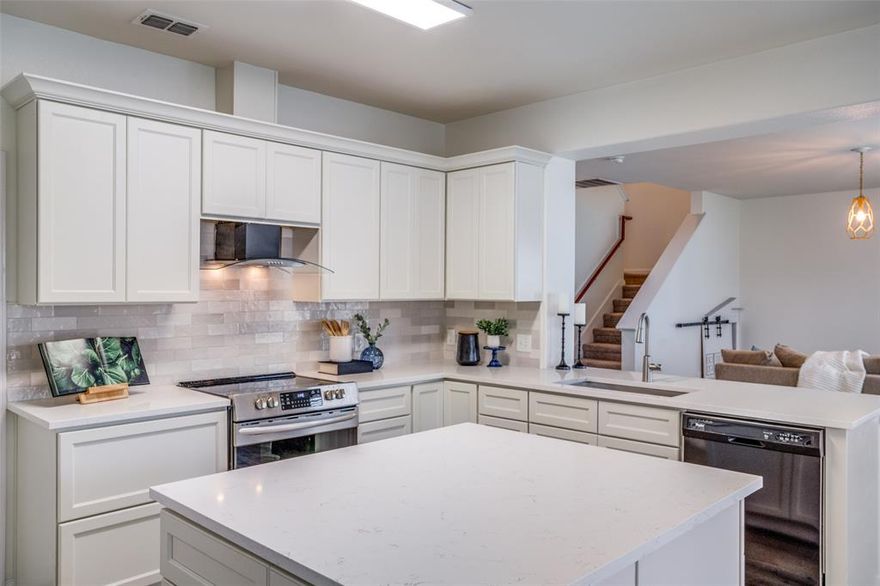 Welcome to your Dream kitchen! Recently installed cream-colored cabinets with soft close drawers, pull out trash, lazy susan corner cabinet, deep drawers for pots and pans, and an oversized island with ample storage! Elegant Zellige Pearl Opal Polished Tile Backsplash and Sleek Carrara Armani Quartz Countertops, Deep Zero Radius sink, modern vent-a-hood, SS Range, LED Flushmount Light Fixture, and breakfast bar across from sink for barstools. Fridge can stay. Blown Glass Decorative Pendant Lights in Dining Room. Excellent natural light from wall of windows overlooking the backyard. Spacious Living Room has custom artisan light fixture. Adorable custom playhouse built-in under the stairs - perfect for kids or pets! Half bath downstairs next to entry. Primary bedroom overlooks backyard, with modern ceiling fan, large walk-in closet and ensuite bath. Spa-like primary bath has Gorgeous Sage cabinets, Carrara Armani Quartz, Andros White Matte 12 x 24 Tile Flooring, Modern LED Light fixture, two recessed lights added above garden tub and separate shower with rain shower head. Wood-look tile downstairs, beautiful neutral carpet upstairs. All carpet replaced March 2026. Freshly painted throughout Feb 2026. Upgraded Lighting throughout. Game Room and Stand alone Laundry room with custom shelving is upstairs. This home has four hallway storage closets! Freshly landscaped front yard with welcoming covered front porch. Spacious, deep Backyard has lots of possibilities! Solar Panels are owned and will transfer to the buyer at closing with no cost to the buyer. No HOA! 0% Down Loan Available.