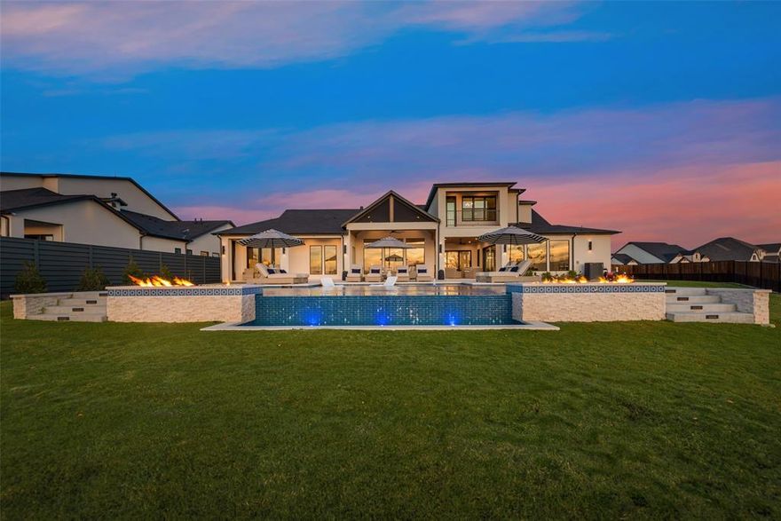 Immaculate modern WATERFRONT home sitting on just over an acre in The Resort on Eagle Mtn. Lake. This home was completed this year and has barely been lived in! Incredible main living area with vaulted- beamed ceilings and large windows overlooking the open water. The first floor has an office, gym, 3 secondary bedrooms with bath attached, primary suite, stunning kitchen and dining room with additional bar and dining space off the kitchen. Upstairs features a theater room and additional bedroom with a full bath and balcony overlooking the backyard and lake. Outside is truly your own private oasis. Enjoy multiple seating areas with electronic screens across the entire patio making it usable year round. The infinity pool and spa has stunning modern fire features overlooking the huge backyard leading you to your personal covered boat dock that's in pristine condition. Top of the line finishes throughout providing the ultimate in modern-luxury living.