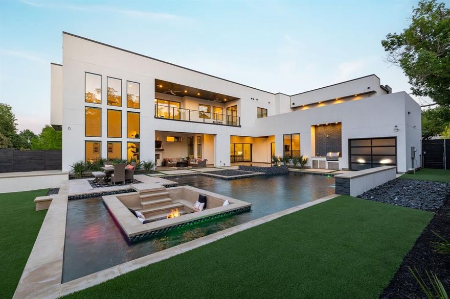 Modern masterpiece completed in 2021. Resort style living in the fairway of Preston Hollow with an open floor plan offers flexible spaces for work, play & entertainment. 30' wall of windows in front & back with soaring ceilings throughout. The heart of the home is the Wolf and Sub Zero kitchen, accompanied by full catering kitchen, 2 walk-in pantries, wet bar, temp-controlled wine room & butler's pantry. The owner's suite with fireplace, private laundry & coffee bar plus 2 ensuite bedrooms are located downstairs. 2 oversized secondary bedrooms, media room, playroom, office, game room with bar, & 2 terraces overlooking the pool are upstairs. Rooms have flexibility to grow with the owners needs. Aquaterra pool with waterfall, sunken lounge & fire pit, spa & in-ground trampoline all illuminated by LED lights. This property embodies modern luxury, functionality and privacy! Convenient location to the Dallas North Tollway, Preston- Royal amenities & the private school corridor.