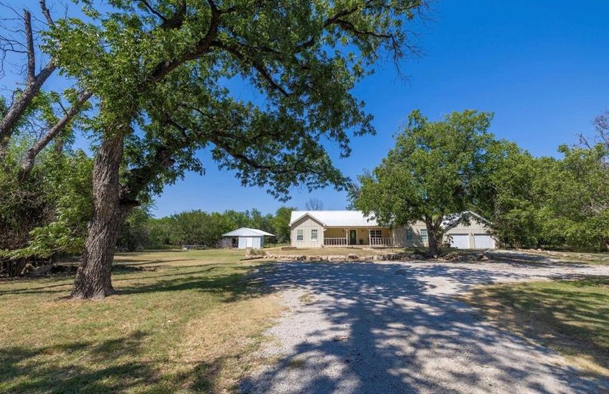 Country living in the heart of town! One of a kind beautiful 4 bedroom,3 bath home on 3.32 acres is sure to please. There is a gated entrance and beautiful drive to the home with towering trees and over 20 producing pecan and fruit trees. The first floor has vaulted ceilings and features two bedrooms, two bathrooms, open concept kitchen and a living area with a cozy fireplace. The primary bedroom has a bonus area that would make a great office or workout spot. The en-suite bath has double sinks, tiled walk in shower and claw foot tub. The grand stairs lead to the basement where you will find an additional two bedrooms, game room-living area with bar and a full bath. There is an incredible storage area offered in the basement as well! The view from the large covered back porch is picturesque and is the perfect place to watch the wildlife and drink your morning cup of coffee. Oversized two car garage plus covered parking for four additional vehicles. HUGE laundry room, metal roof, a pen for chickens and a place for a large garden. Indian Creek boarders the property making this the perfect place to go exploring! Minutes to schools, shopping and dining.  Call for a showing today!