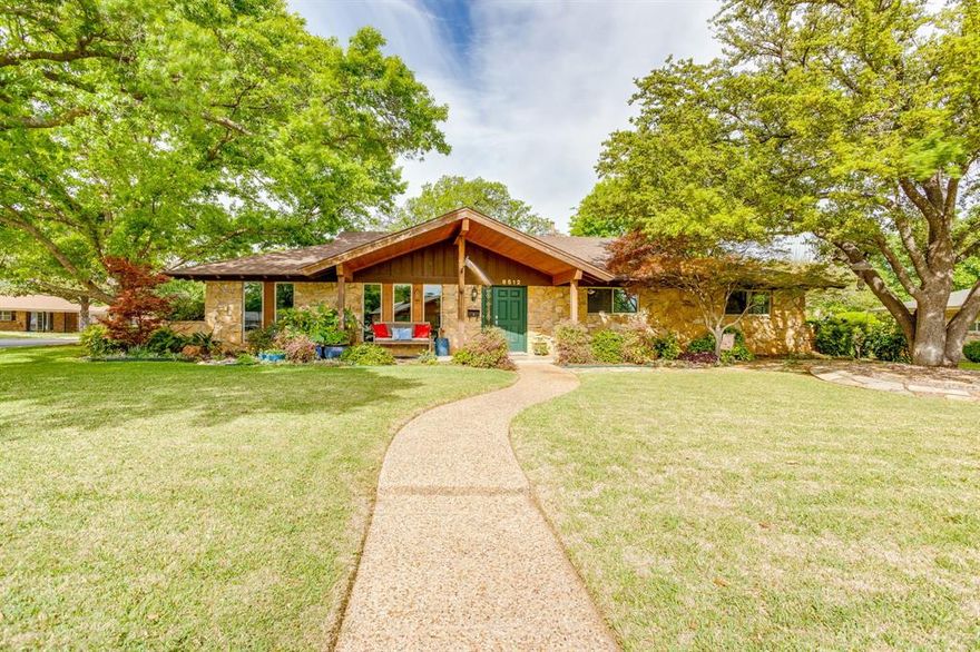 Charming 3-bedroom, 2 and half-bath home situated on an oversized corner lot with beautiful curb appeal and thoughtful upgrades throughout. This spacious home offers an open floorplan complemented by rich Hickory hardwood flooring in the main living areas, creating a warm and inviting atmosphere. The kitchen is a standout feature, boasting granite countertops, custom maple cabinetry, stainless steel appliances, and a premium Electrolux induction stovetop and convection oven—perfect for both everyday living and entertaining. The home also includes both a formal living room and formal dining room, providing flexible spaces for gatherings or a home office. The main living area is anchored by a cozy stone fireplace with gas logs, ideal for relaxing evenings. Additional interior highlights include upgraded energy-efficient Ultrex windows, wood blinds throughout, and new interior doors. Step outside to enjoy large covered patios at both the front and back of the home, surrounded by mature landscaping and supported by a full sprinkler system. The backyard also features a 14x12 custom-built workshop with electricity, new windows, and built-in cabinetry with countertops—perfect for hobbies, storage, or workspace needs. Additional features include a security system and numerous upgrades that enhance both comfort and efficiency.