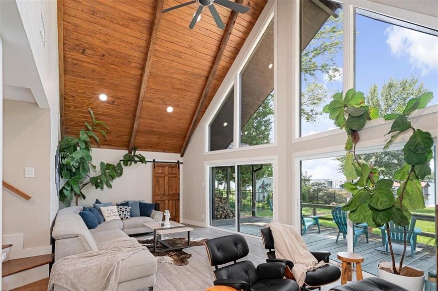 Enjoy this tranquil setting and stunning lake home for all that it offers or use it as your guest home and build a larger home on the second lot! Beautifully recreated A frame design sitting on one of the few double lots in Enchanted Oaks looking out on open water. Room to build a larger home on second buildable lot and meanwhile enjoy this stunning home; gutted and updated in 2020 with all new cabinets, fantasy brown leather finish granite countertops, stainless appliances, recessed lighting, tile floors, marble fireplace and master shower, tongue and groove wood ceilings and  windows. Dock rebuilt in 2024. Wrought iron fencing, 2023.