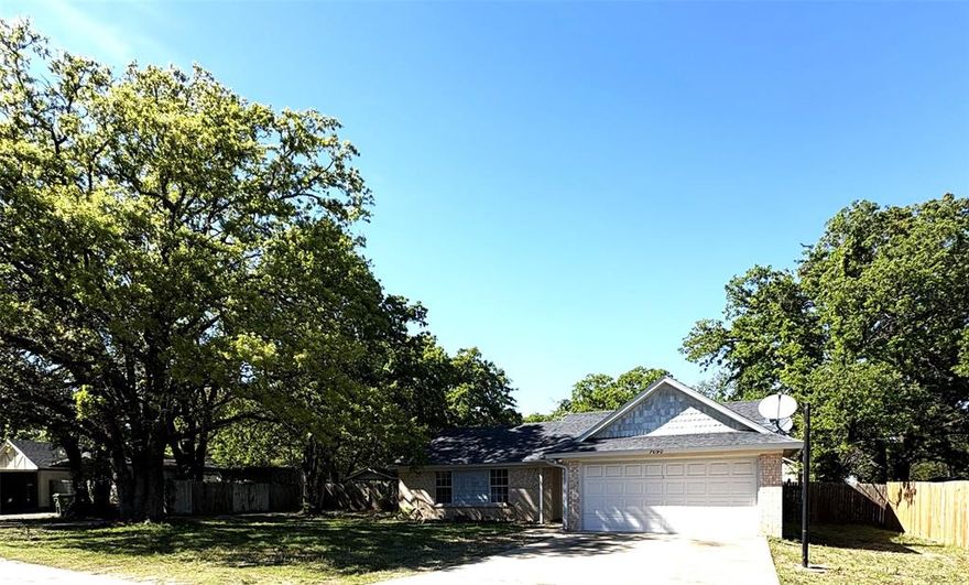 Appealing & Delightful Home On A Large Shady Lot!! All Freshly Updated For The New Owners!! This comfortable & spacious brick home offers three large bedrooms and two full baths, & double car garage! It's complete with a cozy fireplace, perfect for relaxing evenings. The cordial kitchen includes good cabinetry & storage, a pantry closet, a great fridge, & a nice breakfast bar, open to the living area, while the dining area enjoys a large picture window to the pretty back yard! The home has been recently updated with fresh paint and newer flooring, making it a clean, move in ready choice! You'll appreciate the split bedroom arrangement for privacy too! Situated on a generous third-acre lot, the property provides plenty of outdoor space to enjoy. The huge back yard has privacy fencing on either side but the back is wire fencing, which provides serene views of the quiet & peaceful nature behind!  This neighborhood also features a fenced PARK WITH PRIVATE ACCESS TO EAGLE MOUNTAIN LAKE - adding a great recreational benefit for homeowners! You'll enjoy wonderful family times, fishing, boating, having picnics, watching the kids run & play! This nice park is gated, fenced and secure. It includes covered picnic areas with tables & grills, more scattered tables, lots of shade trees, a boat launch, boat & fishing dock w-pier, playgrounds w-equipment, nice open areas for family games, & much more! This neighborhood home offers a quiet & peaceful life with plenty of room & spaces for entertaining & enjoying the outdoors! It is most definitely a nice home offered at an attractive price. Don't miss this one! Call me soon!!