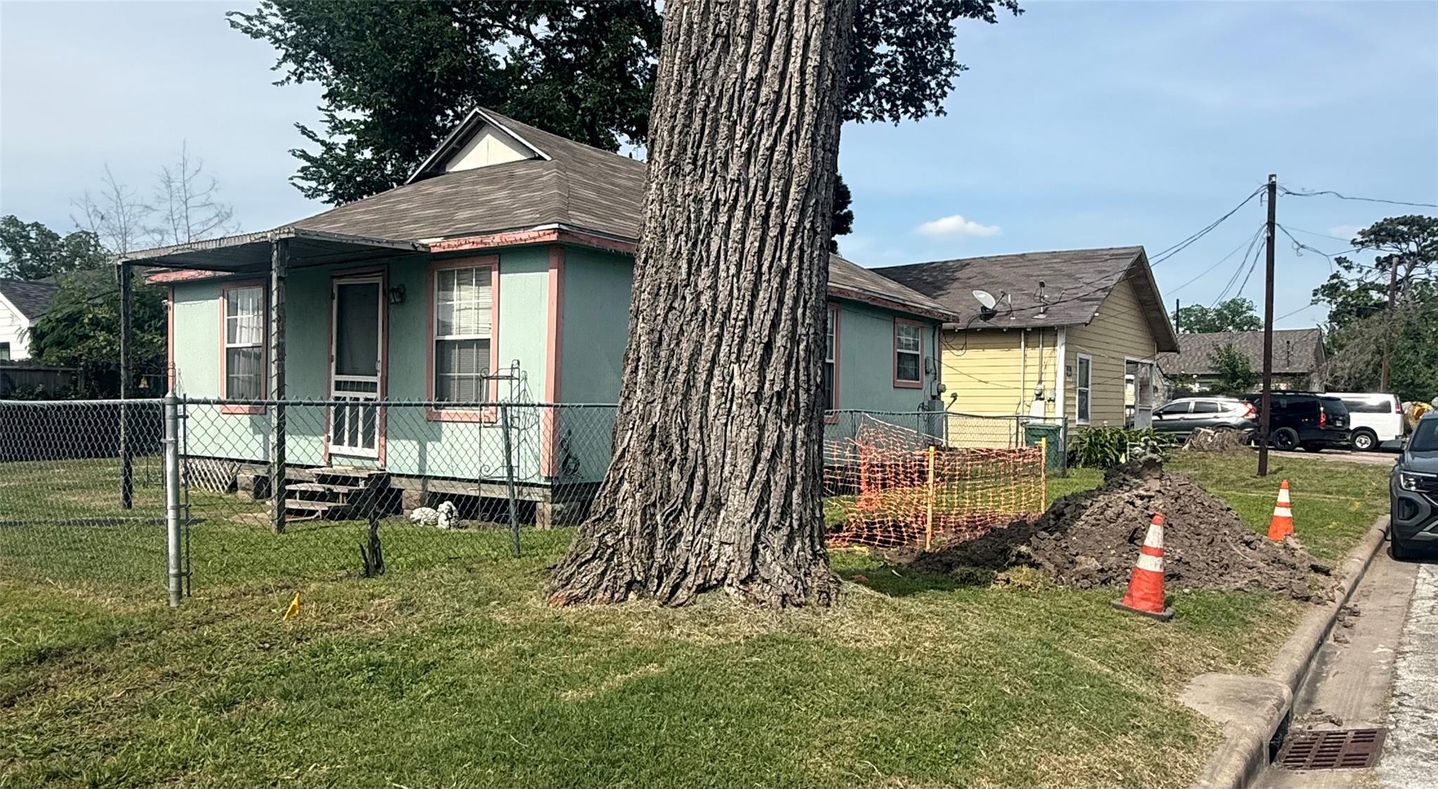 4202 Gano St, house is green and pink trim, 1307 Egypt is the house is yellow behind it.