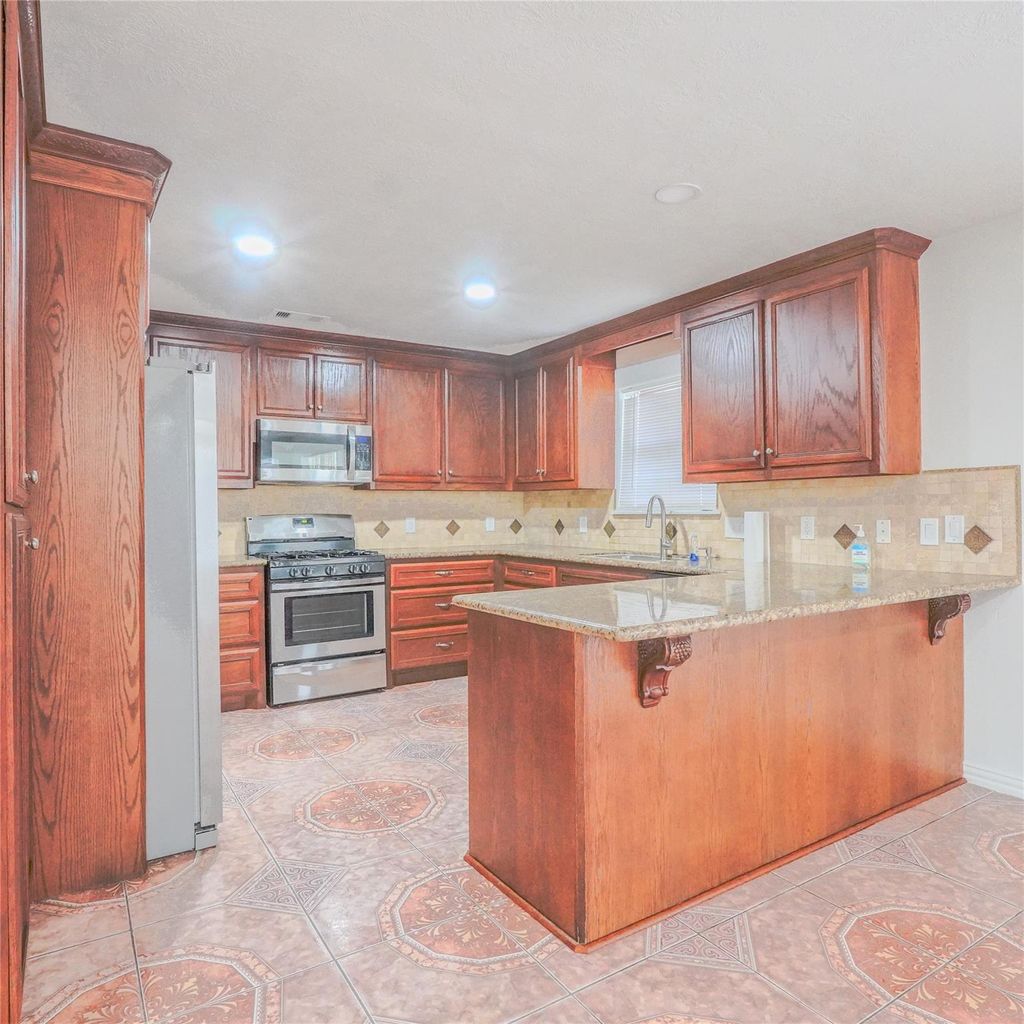 Photo of 9018 Mcgallion Road, Houston, TX 77022 (MLS # 62945728)