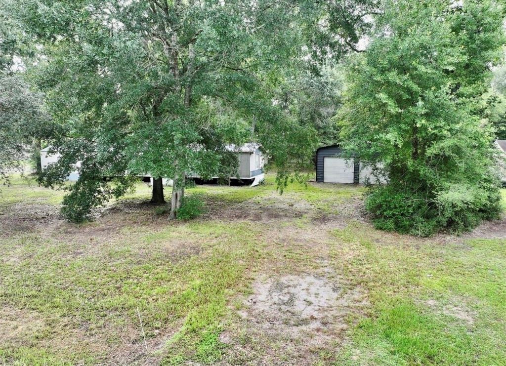 Photo of 214 County Road 2800, Cleveland, TX 77327 (MLS # 86347349)
