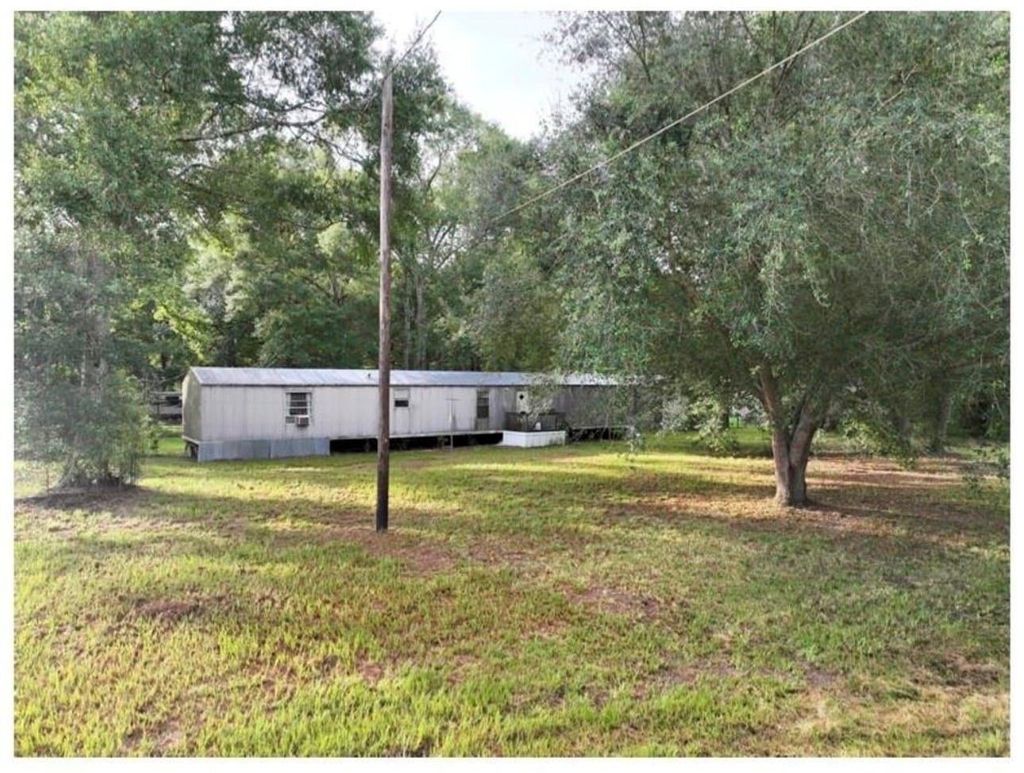 Photo of 214 County Road 2800, Cleveland, TX 77327 (MLS # 86347349)