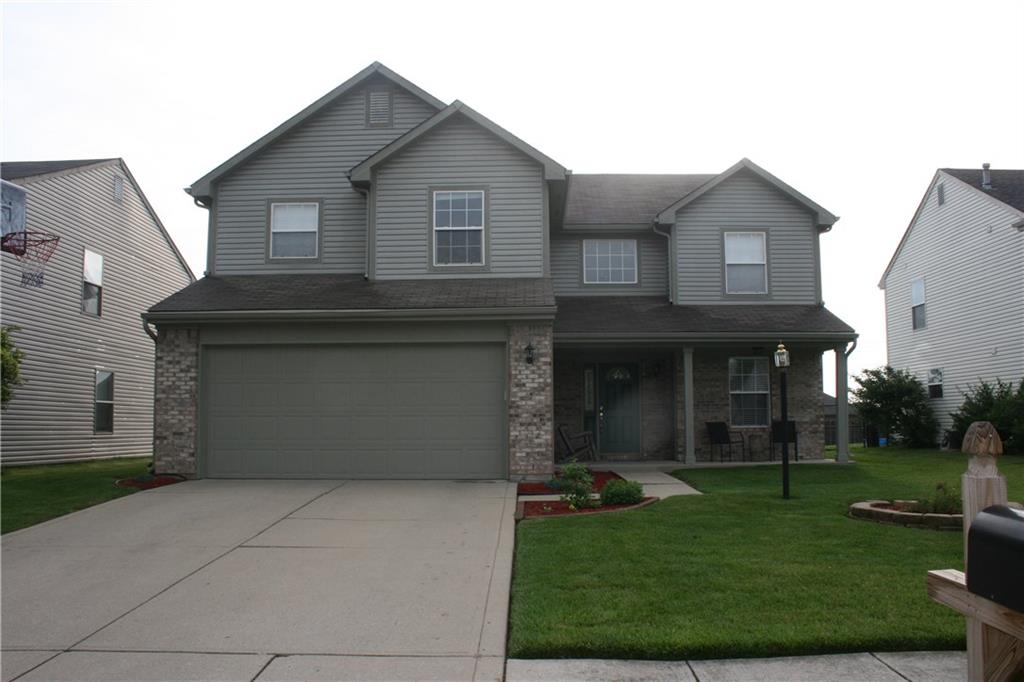 Beautiful curb appeal created by freshly painted exterior, and neat and tidy landscaping and lush green grass.
