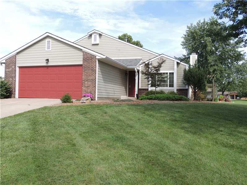Exterior Front. Freshly painted trim work, new exterior light fixtures, manicured lawn and a variety of planting specimens.