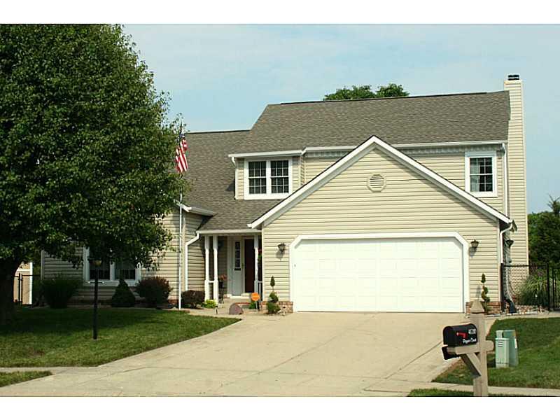 Exterior Front. Spacious 2-level home with mature trees, flag pole, and brick wrap accent at the end of a quiet cul-de-sac.