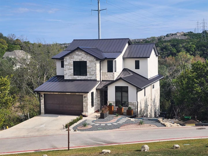 Modern inspired farmhouse featuring stone siding