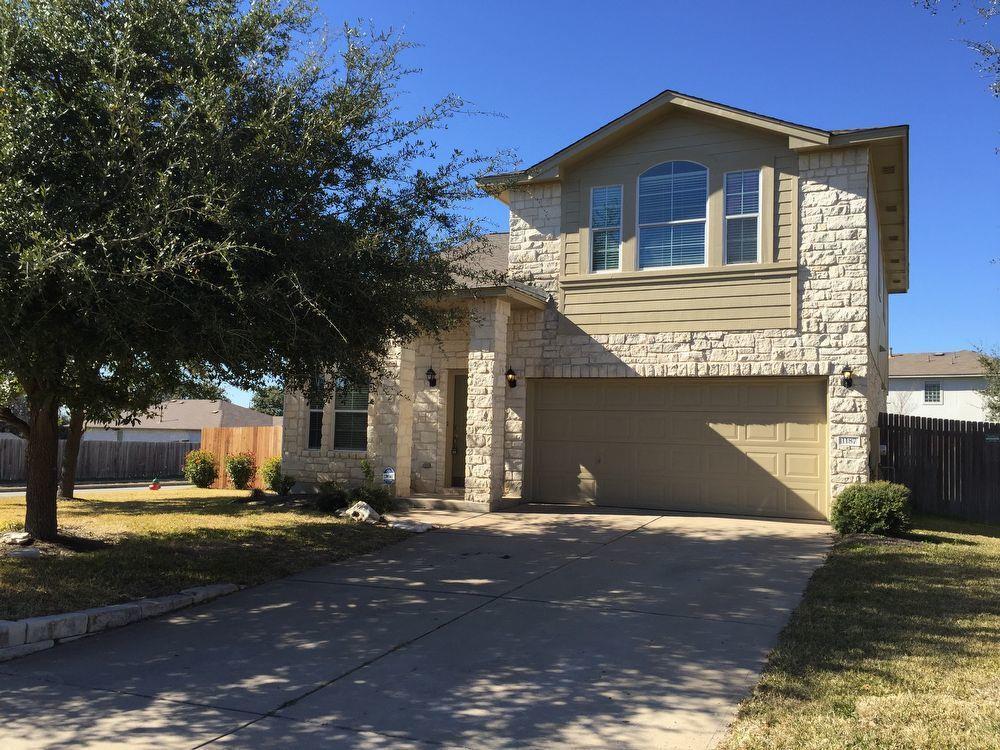 Two-story residence featuring a stone and siding