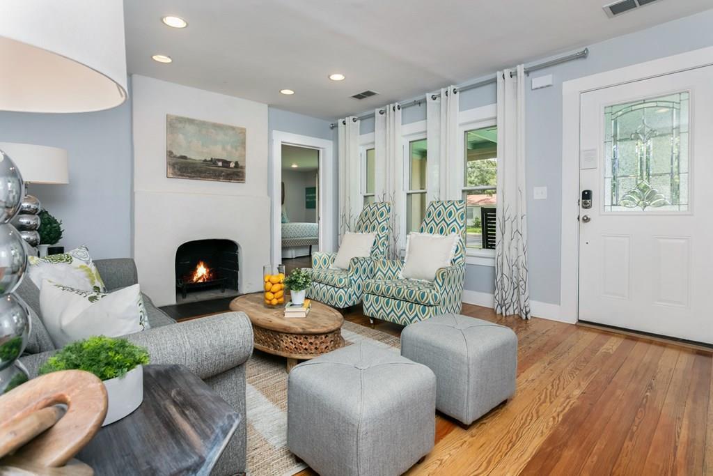 Sitting room featuring a warm lit fireplace, wood