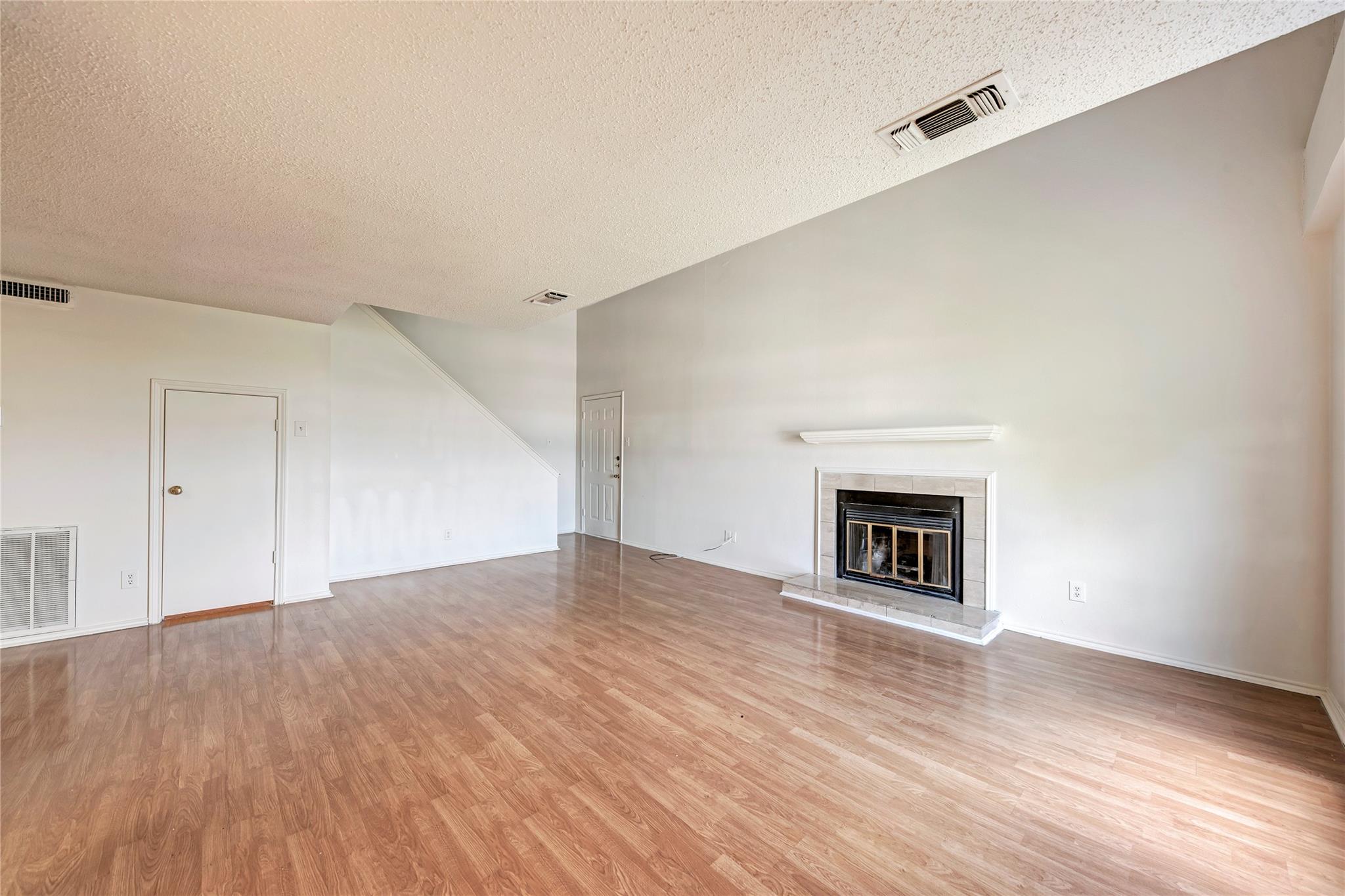 Spacious living area featuring wood-finish floori