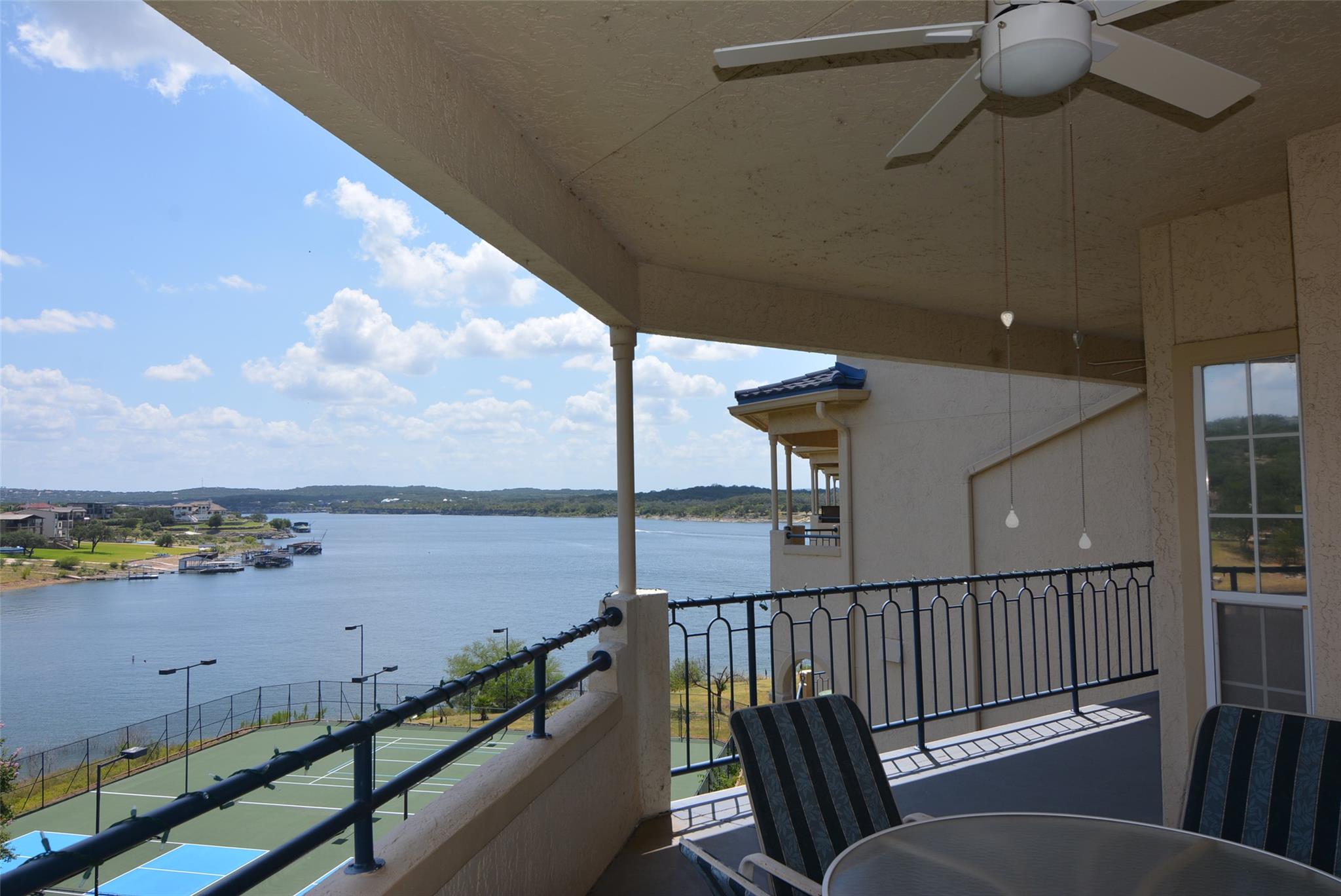Balcony with outdoor dining space and a water view
