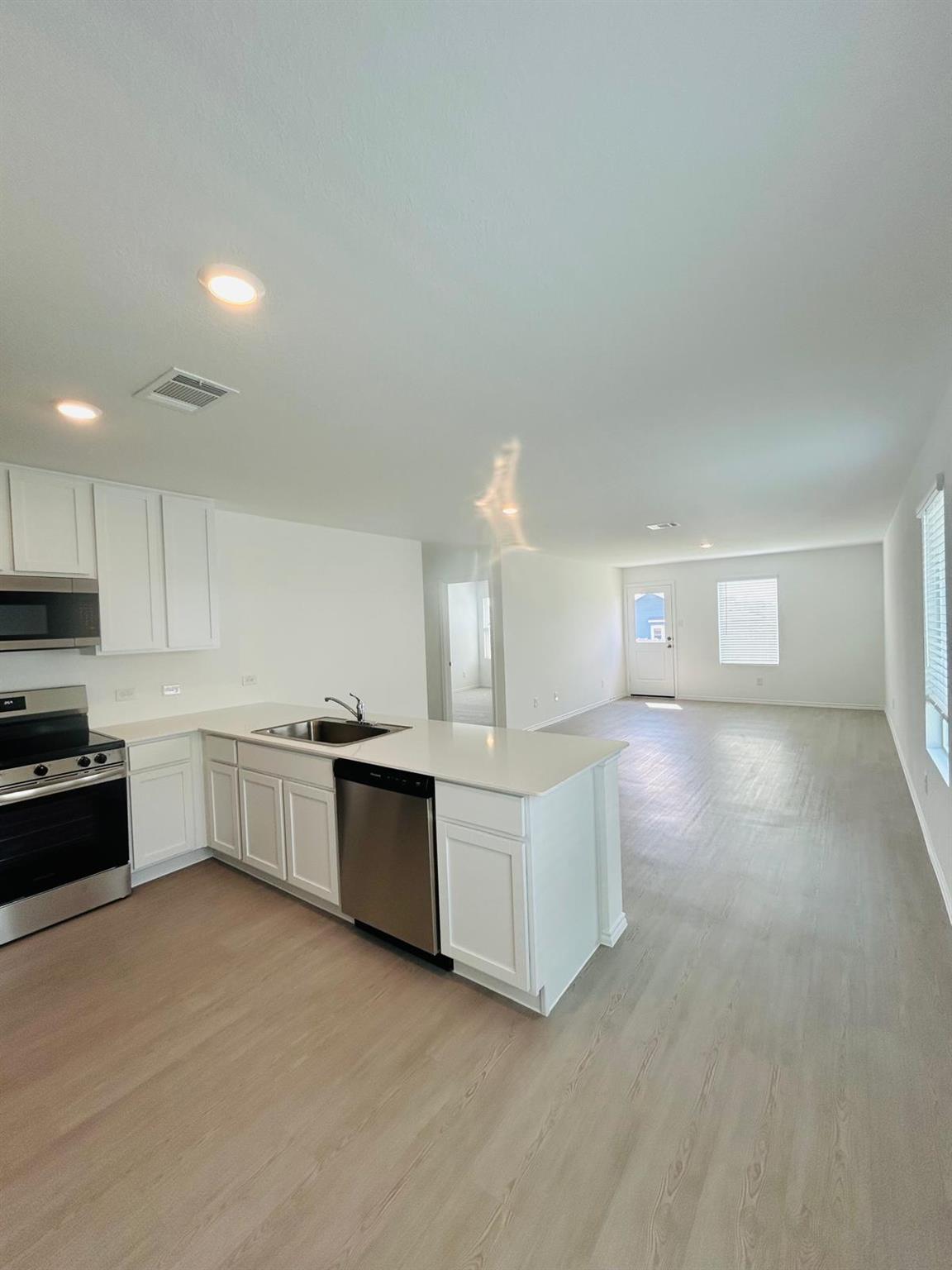 Kitchen with stainless steel appliances, white ca