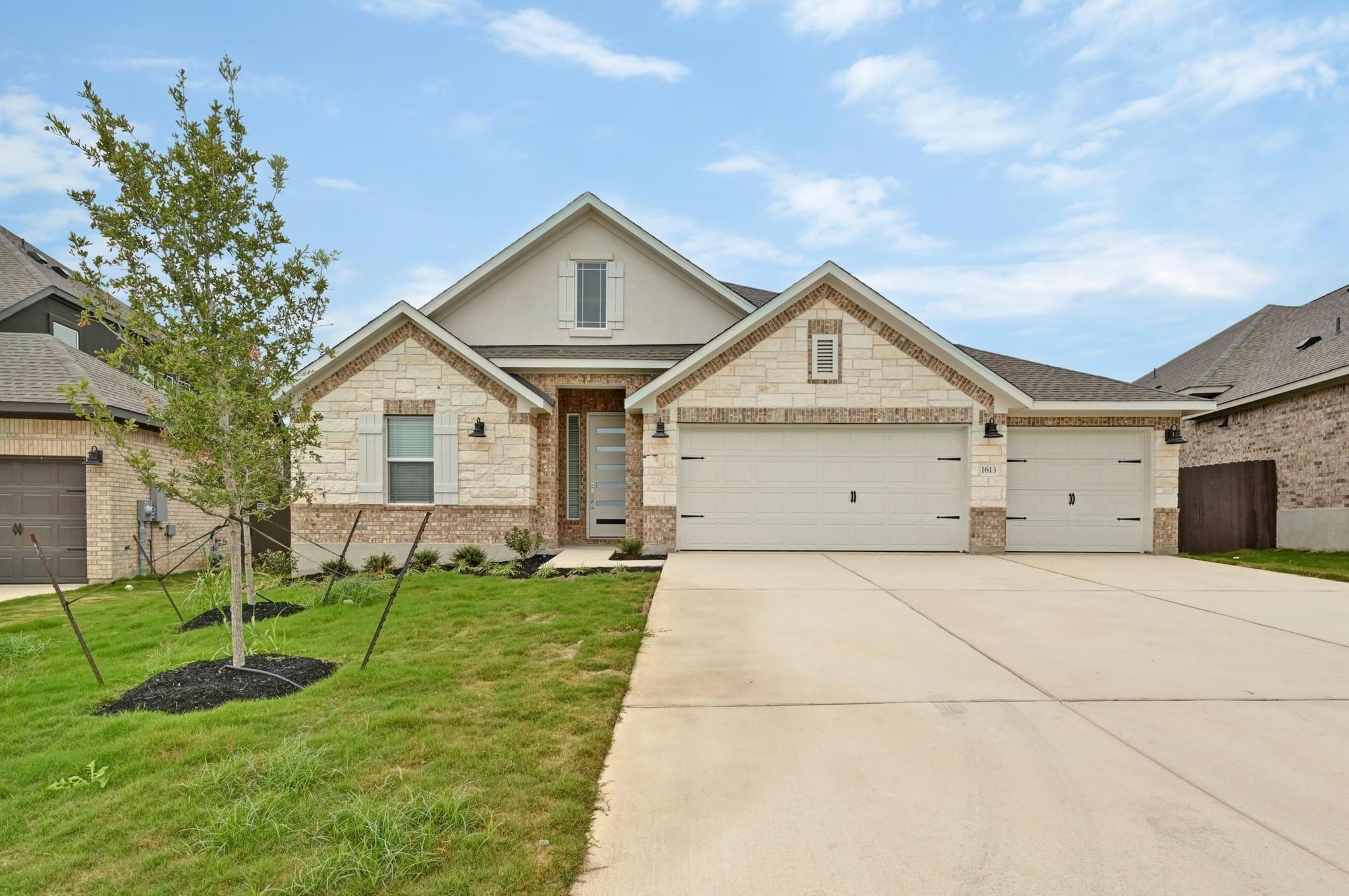 View of front facade with a front yard, brick sid