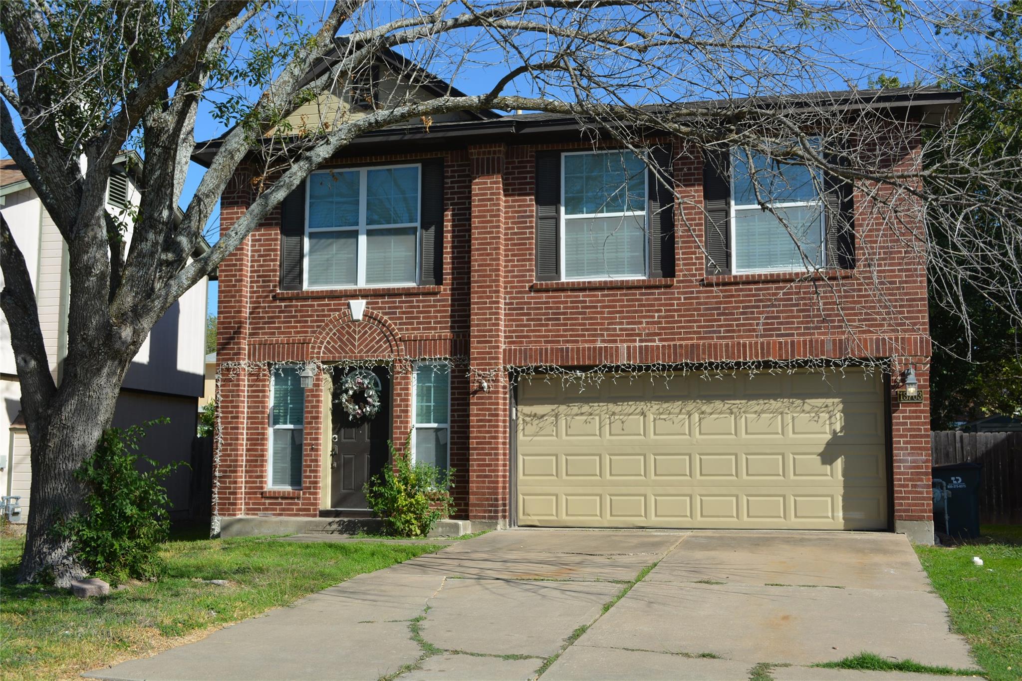 View of front facade featuring driveway, an attac